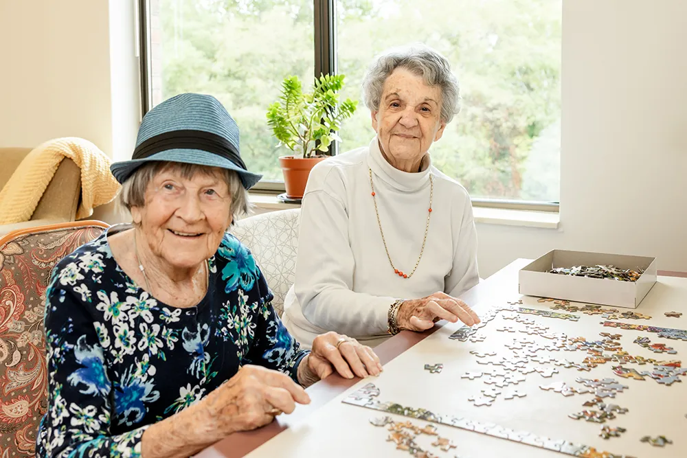 Senior ladies build a puzzle together