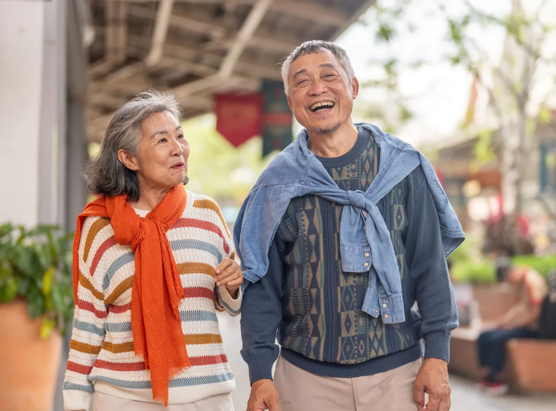 couple-walking-outdoors-1 Senior couple walking arm-in-arm and smiling outdoors